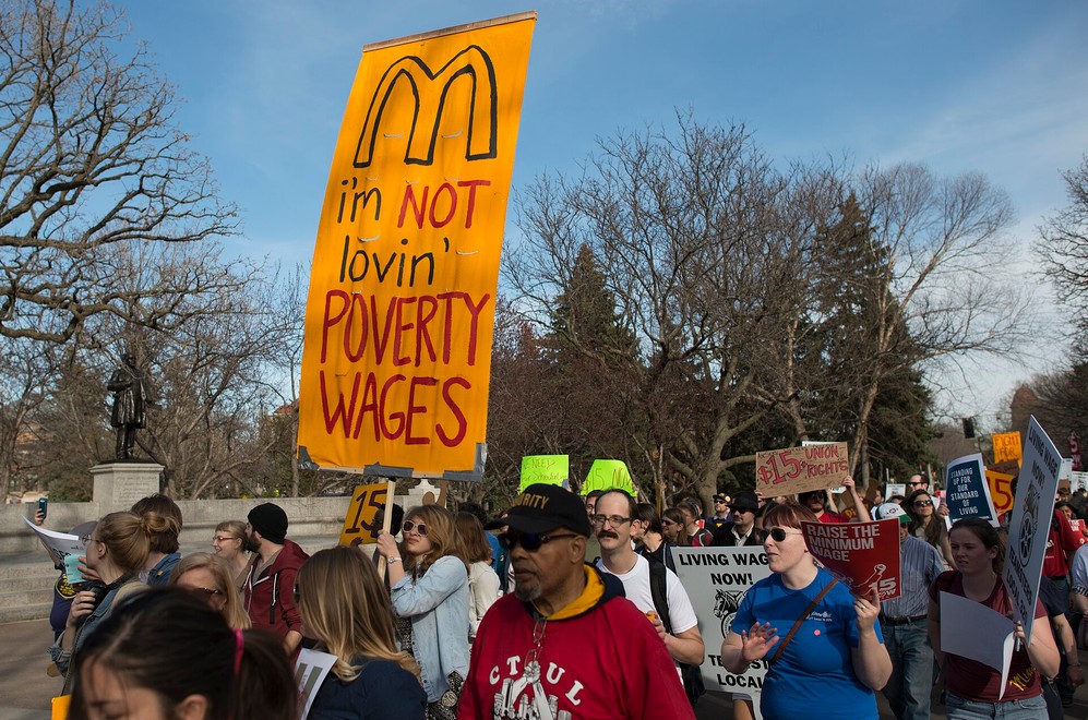 April 15, 2015 Food workers across the USA walked out on strike to hold protests and marches demanding a $15/hour minimum wage. In the Twin Cities, striking fast food workers were joined by university workers, students, janitors, retail workers, and airport workers. They call for a $15/hour minimum wage, paid sick days, and fairer scheduling of work hours.